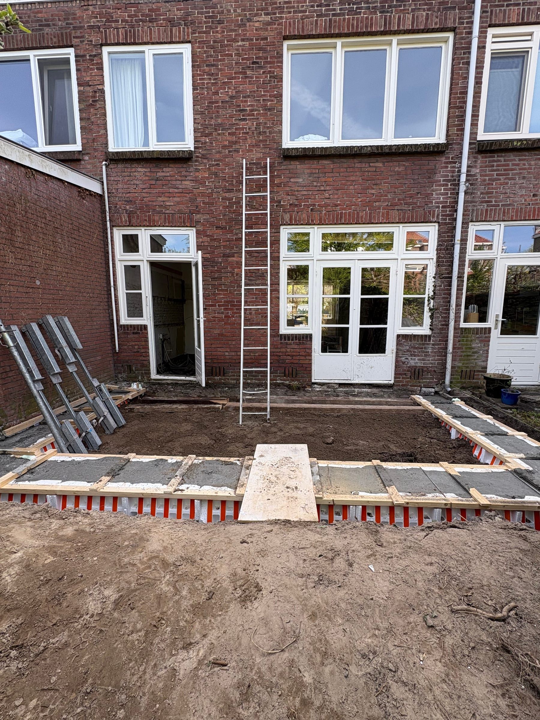 Fundering voor de aanbouw in de bekisting, aan de achterkant van de woning