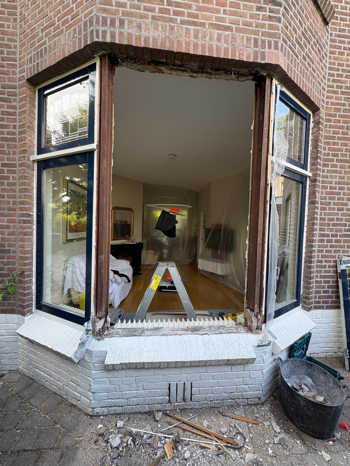 Dezelfde erker tijdens het werk: de oude kozijnen eruit, de gevel open